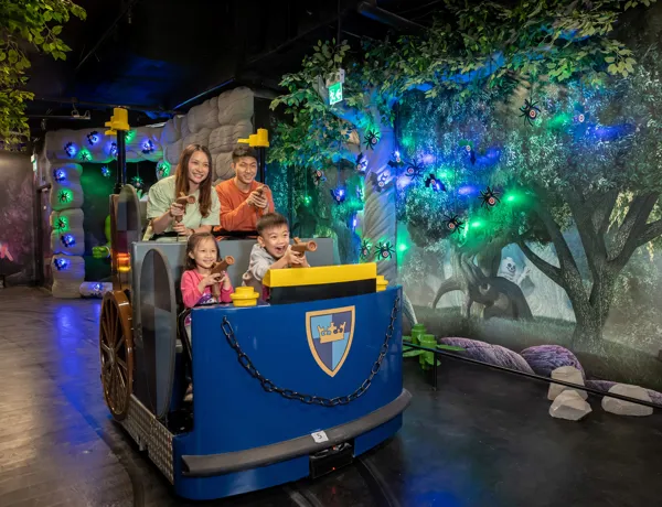 Parents and kids are riding the chariot in the Kingdom Quest ride.