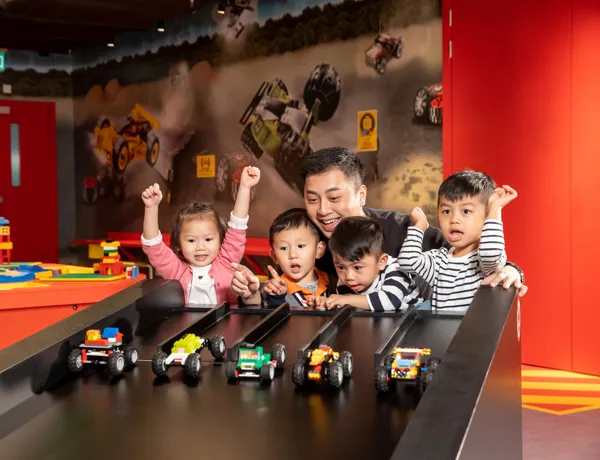 Kids are racing cars againest each other at LEGO® RACER