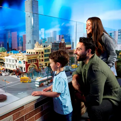 parents and kids looking at miniland